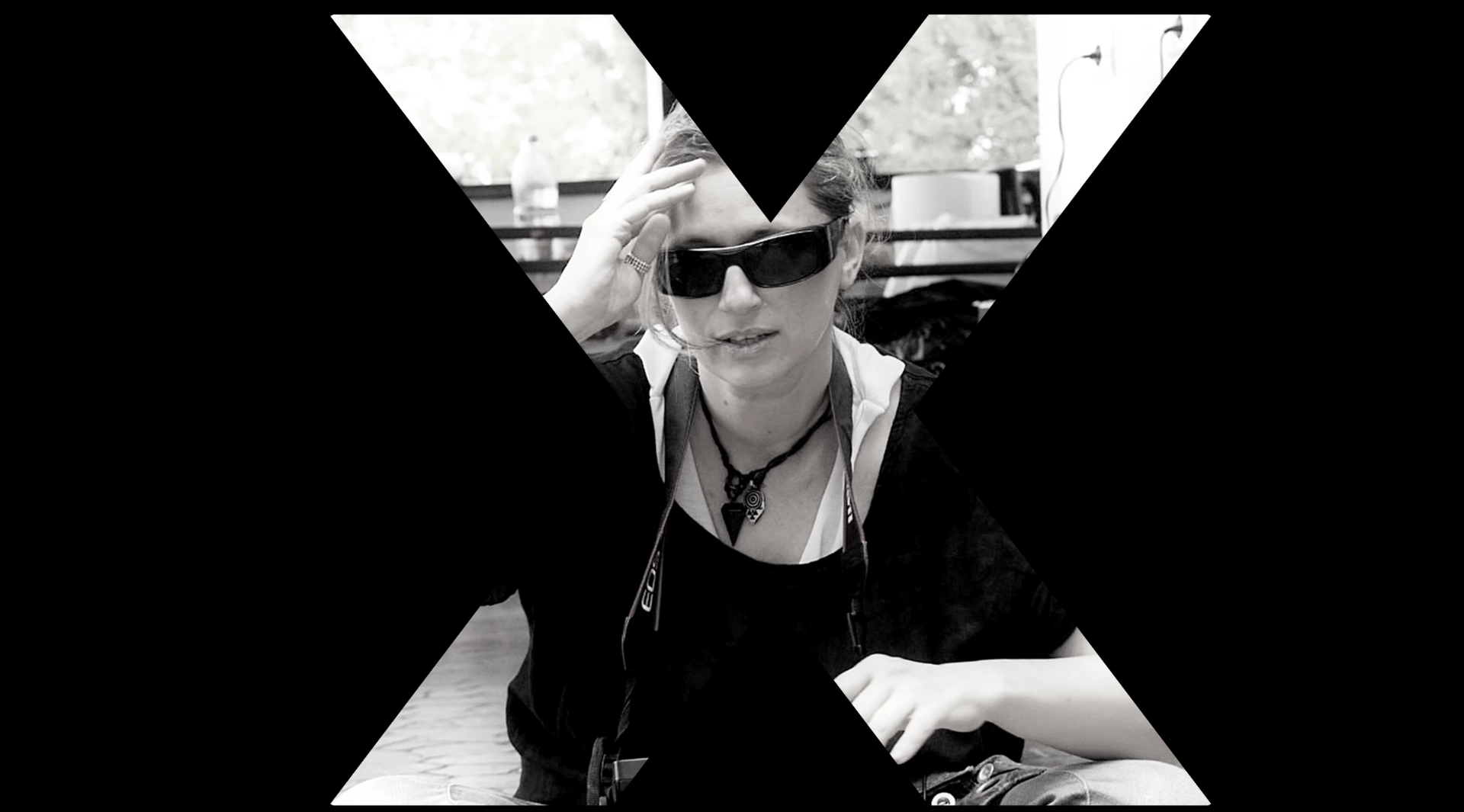 Georgia Mihalcea, author and problem solver, in sunglasses, symbolizing resilience and the XFactor in entrepreneurship, framed by an 'X'